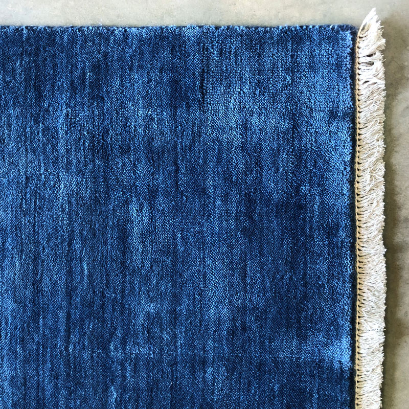 Blue rug with fringe
